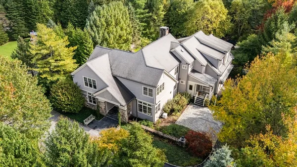 an aerial view of a house with a yard patio and garage