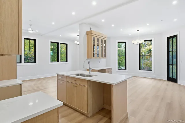 a view of a big room with kitchen view and windows