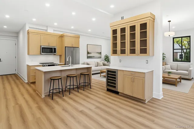 a kitchen with stainless steel appliances kitchen island granite countertop a stove and a sink