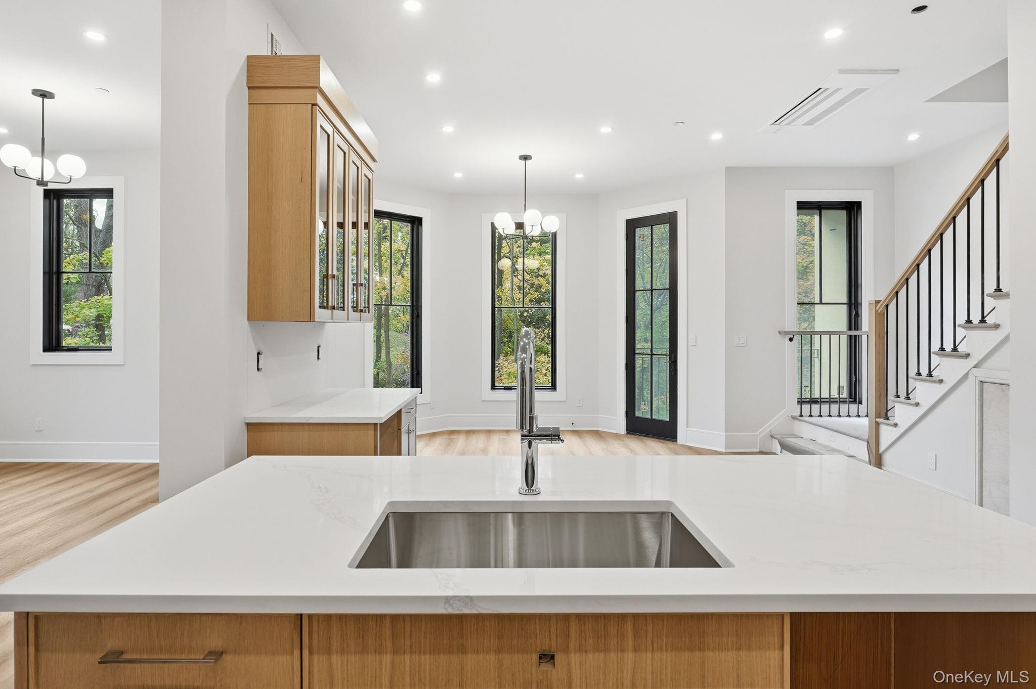 34 Clinton Avenue, Unit 5D Dobbs Ferry, NY 10522 - Photo 7 of 13 a view of kitchen with kitchen island a sink and a refrigerator