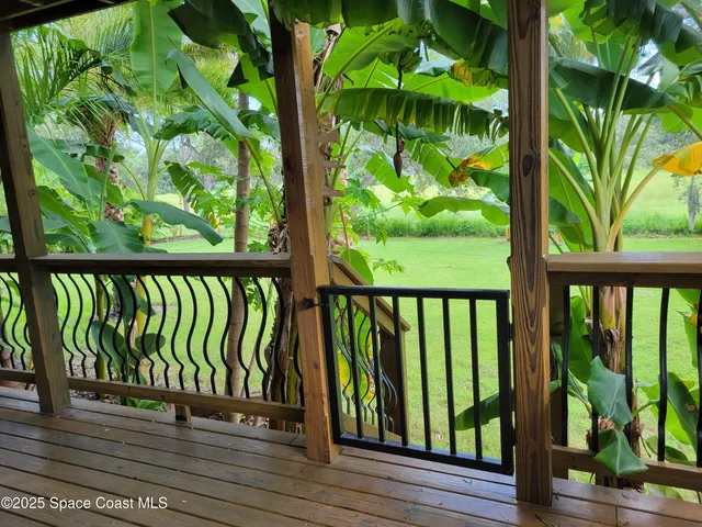 a view of balcony with chairs and wooden floor