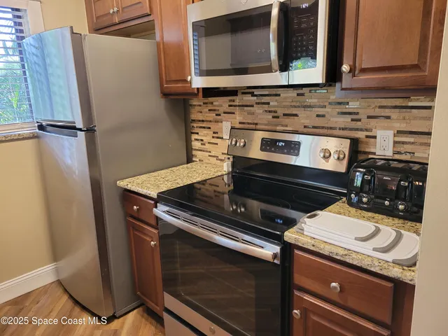 a stove top oven sitting inside of a kitchen