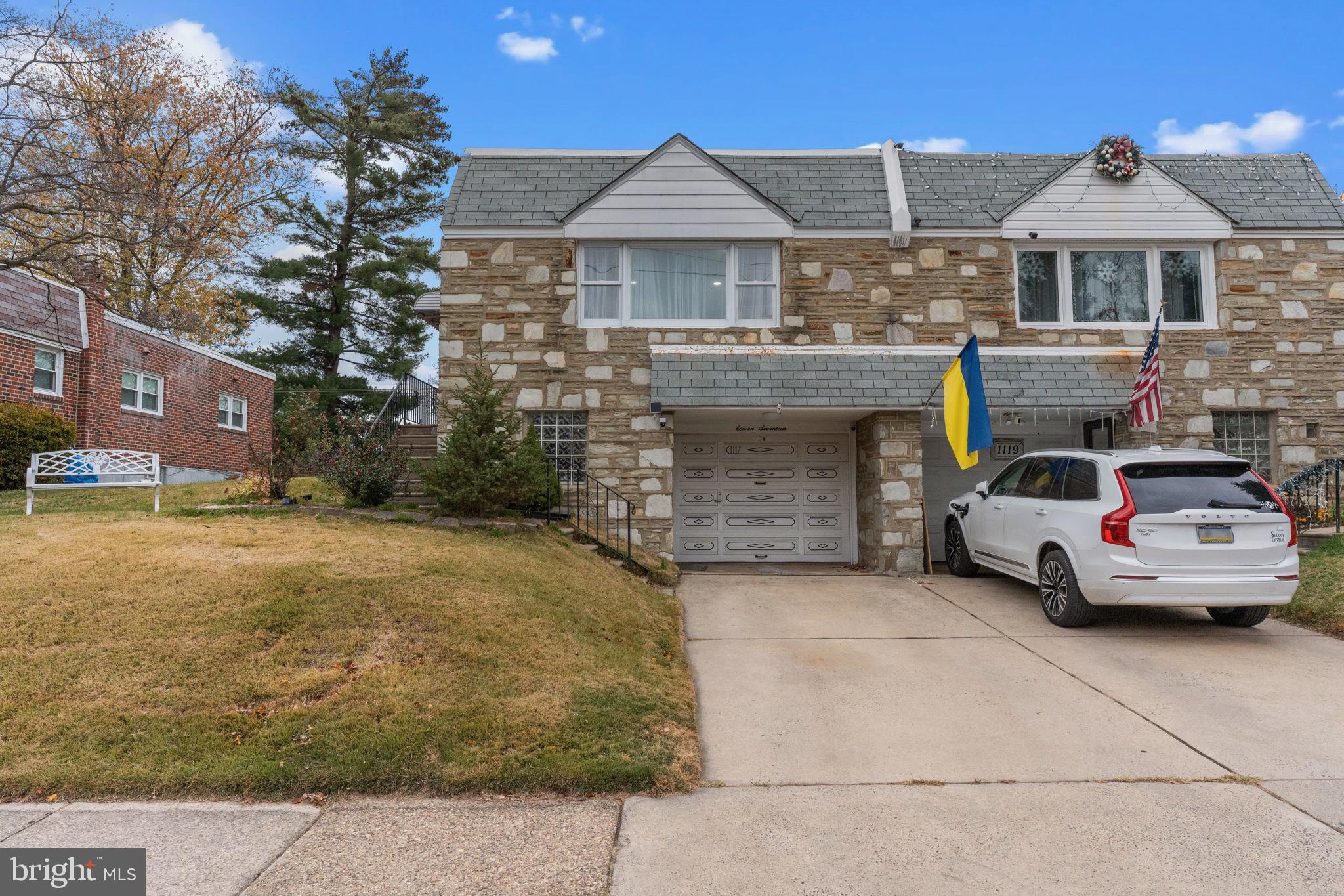 1117 Surrey Road Philadelphia, PA 19115 - Photo 1 of 24 a car parked in front of a brick house