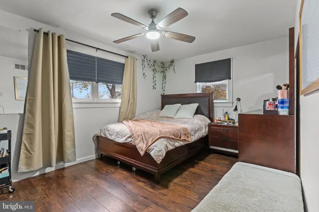 a bedroom with a large bed chandelier and a window