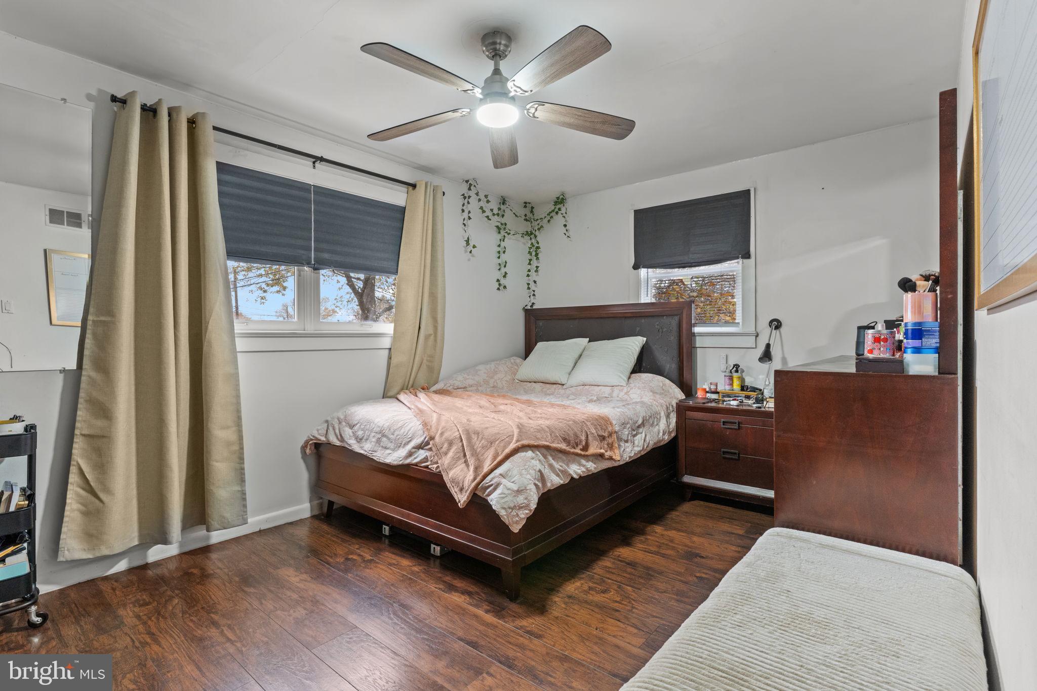 1117 Surrey Road Philadelphia, PA 19115 - Photo 12 of 24 a bedroom with a large bed chandelier and a window