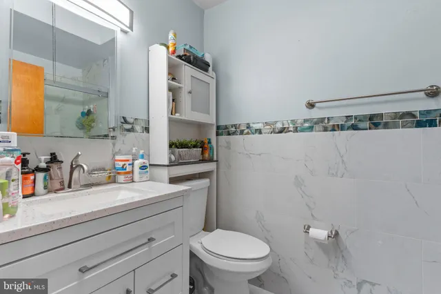 a bathroom with a sink a toilet and mirror