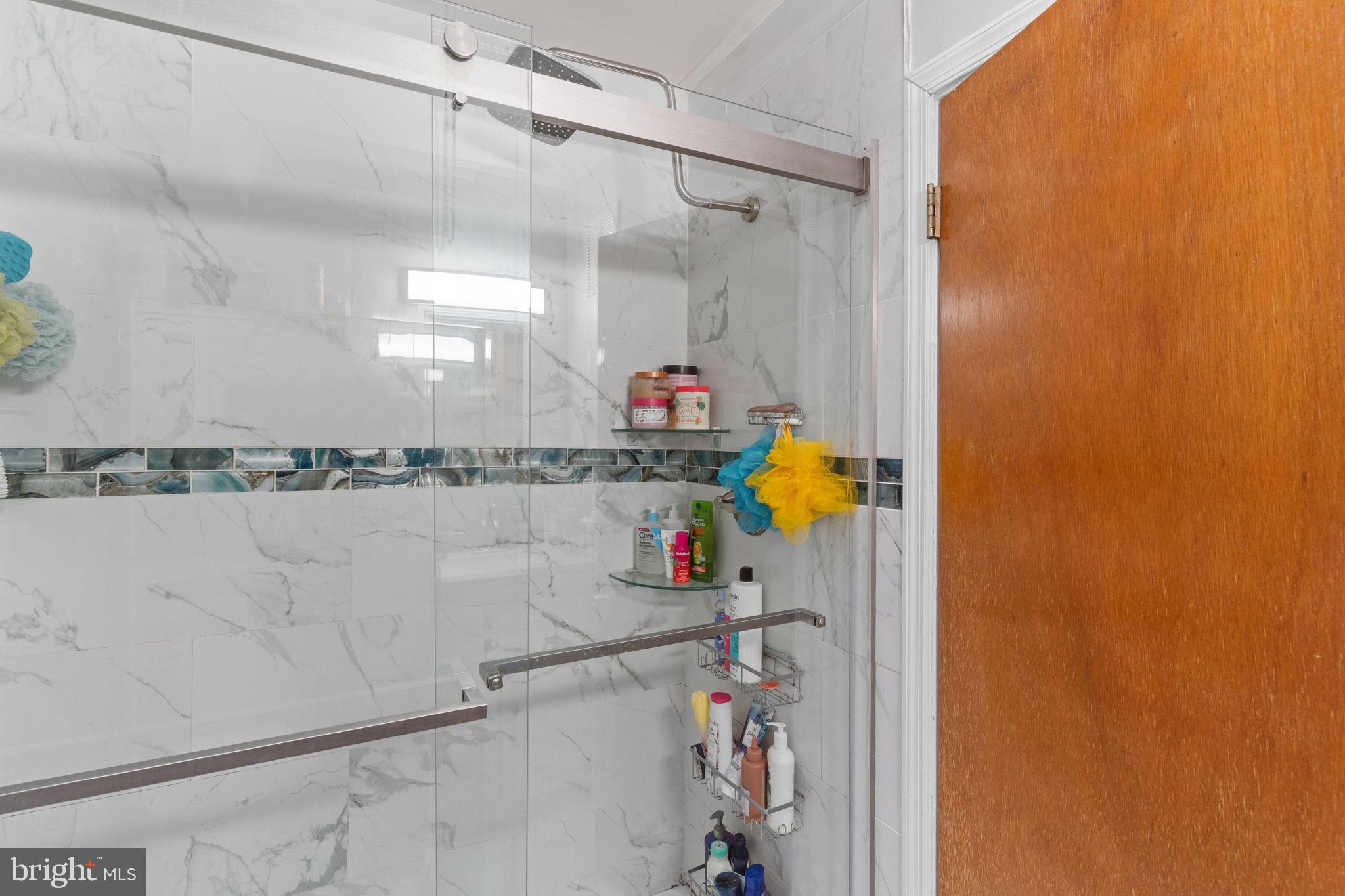 1117 Surrey Road Philadelphia, PA 19115 - Photo 14 of 24 a bathroom with a mirror and a shower