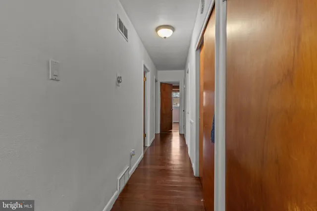 a view of hallway with wooden floor
