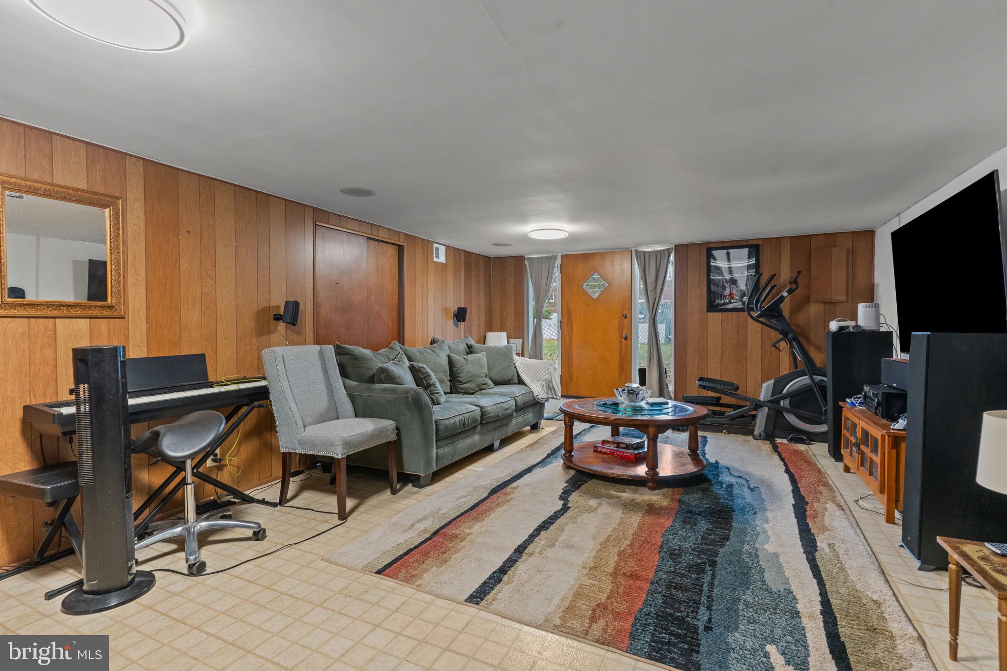 1117 Surrey Road Philadelphia, PA 19115 - Photo 16 of 24 a living room with furniture a flat screen tv and a fireplace