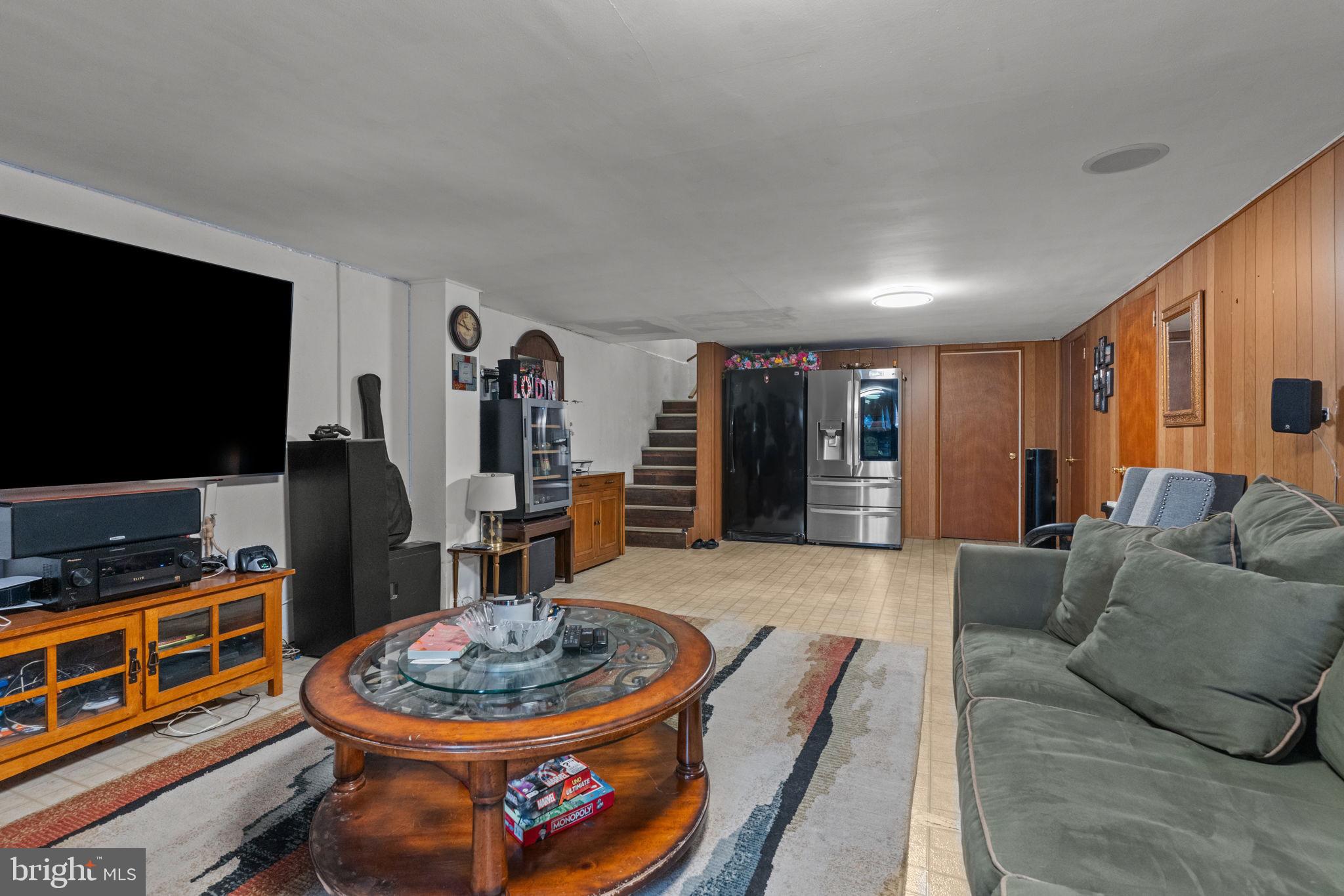 1117 Surrey Road Philadelphia, PA 19115 - Photo 17 of 24 a living room with furniture and a flat screen tv