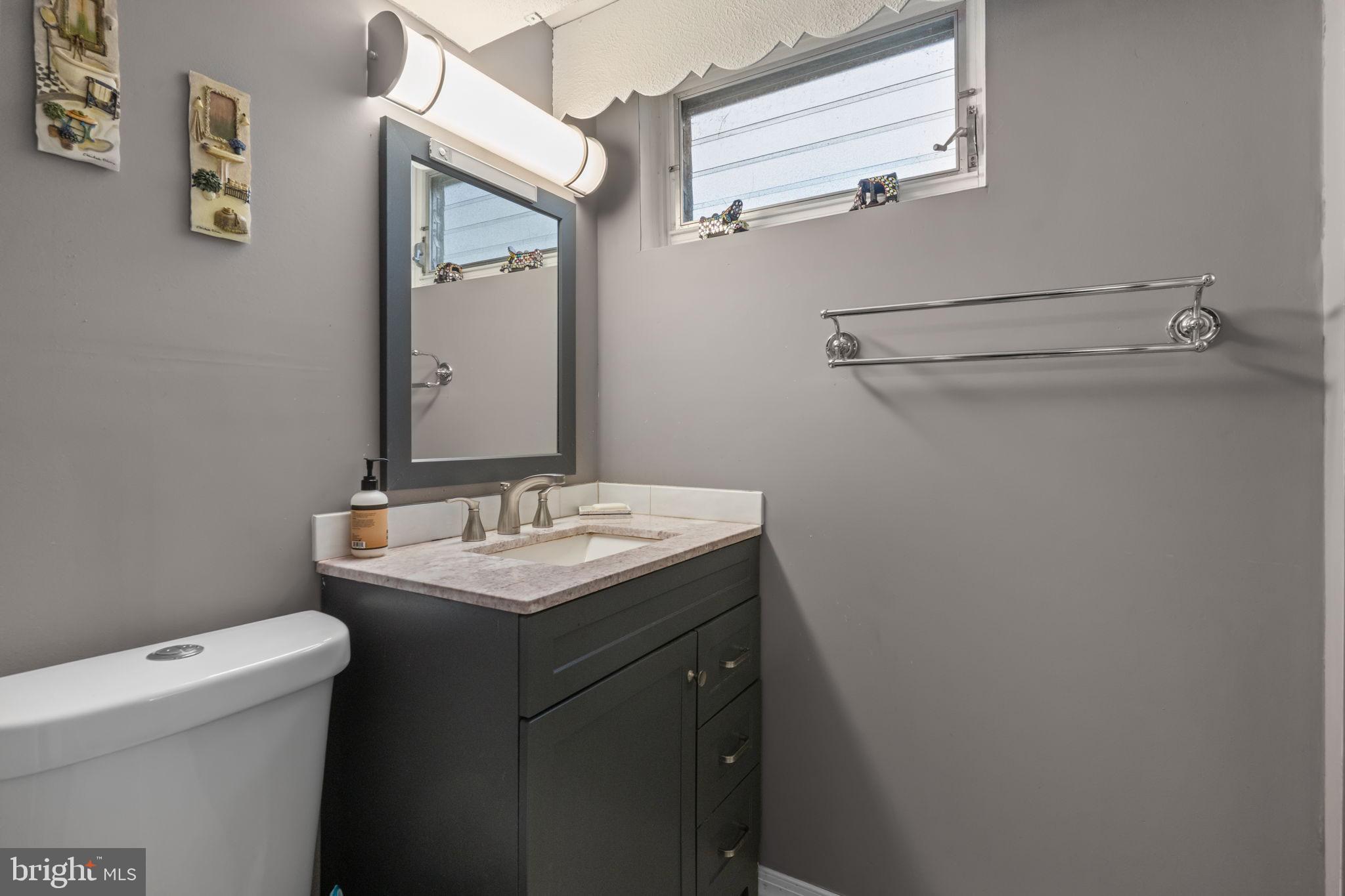 1117 Surrey Road Philadelphia, PA 19115 - Photo 18 of 24 a bathroom with a granite countertop sink and a toilet