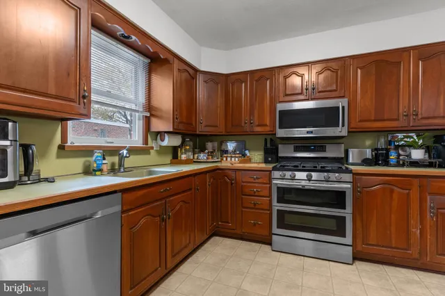 a kitchen with stainless steel appliances granite countertop a stove microwave and sink