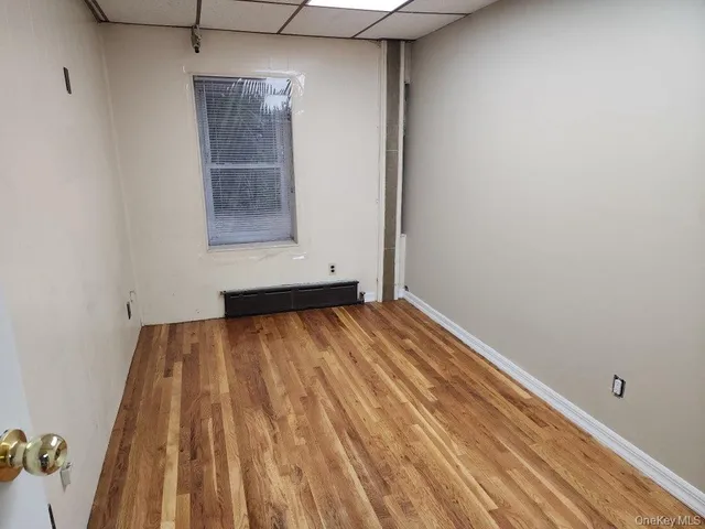 a view of room with window and hardwood floor