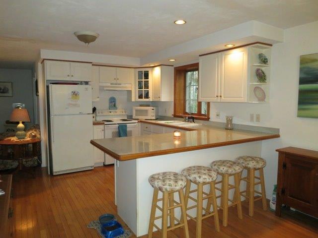 62 Riverside Road Mashpee, MA 02649 - Photo 6 of 13 a kitchen with stainless steel appliances granite countertop a sink and a refrigerator