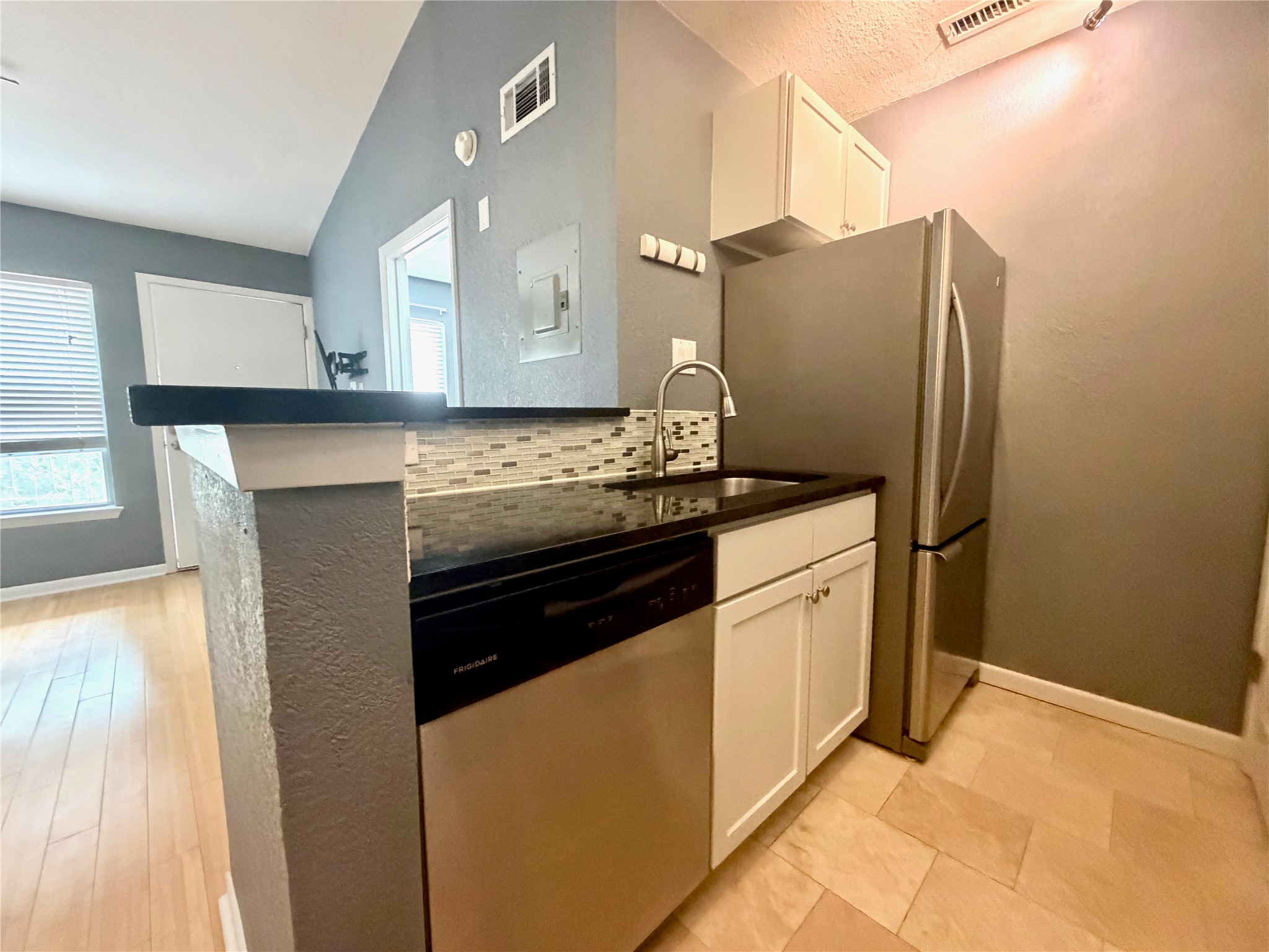 3204 Manchaca Road, Unit 302 Austin, TX 78704 - Photo 7 of 20 Gleaming stone countertops and stainless steel appliances elevate this modern kitchen design.