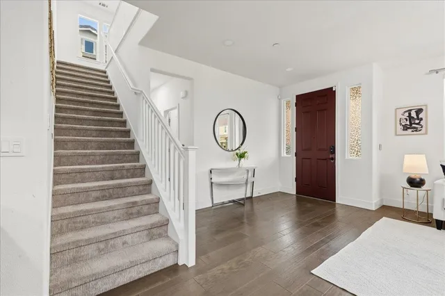 a view of a hallway with wooden floor and workspace