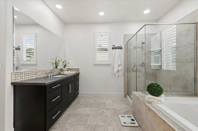 a bathroom with a sink double vanity and a tub