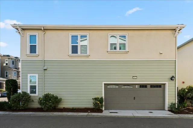 an aerial view of residential houses with outdoor space and lake view