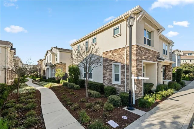 a front view of a house with garden