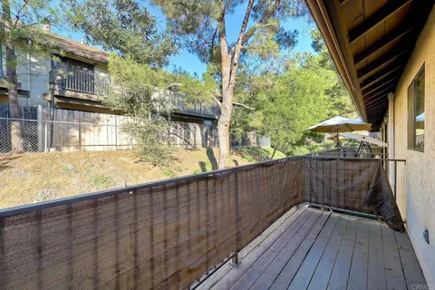 a view of balcony with wooden floor