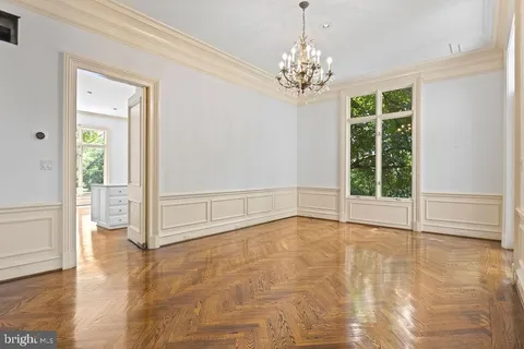 a kitchen with a stove a sink a center island and windows