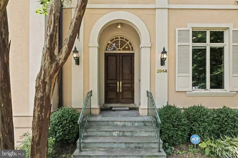 a view of a house with potted plants