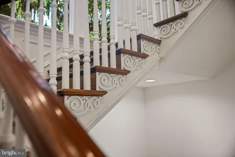 a view of hallway with wooden floor