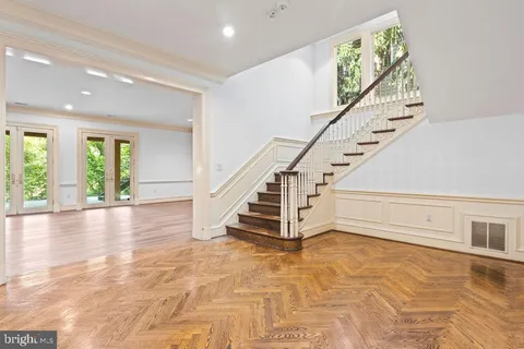 a view of empty room with wooden floor and fireplace