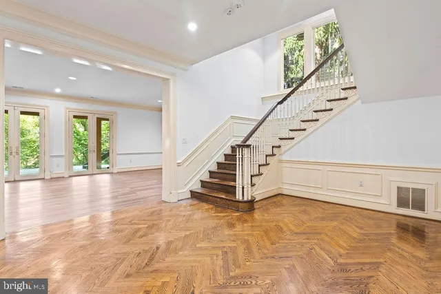 a view of empty room with wooden floor and fireplace