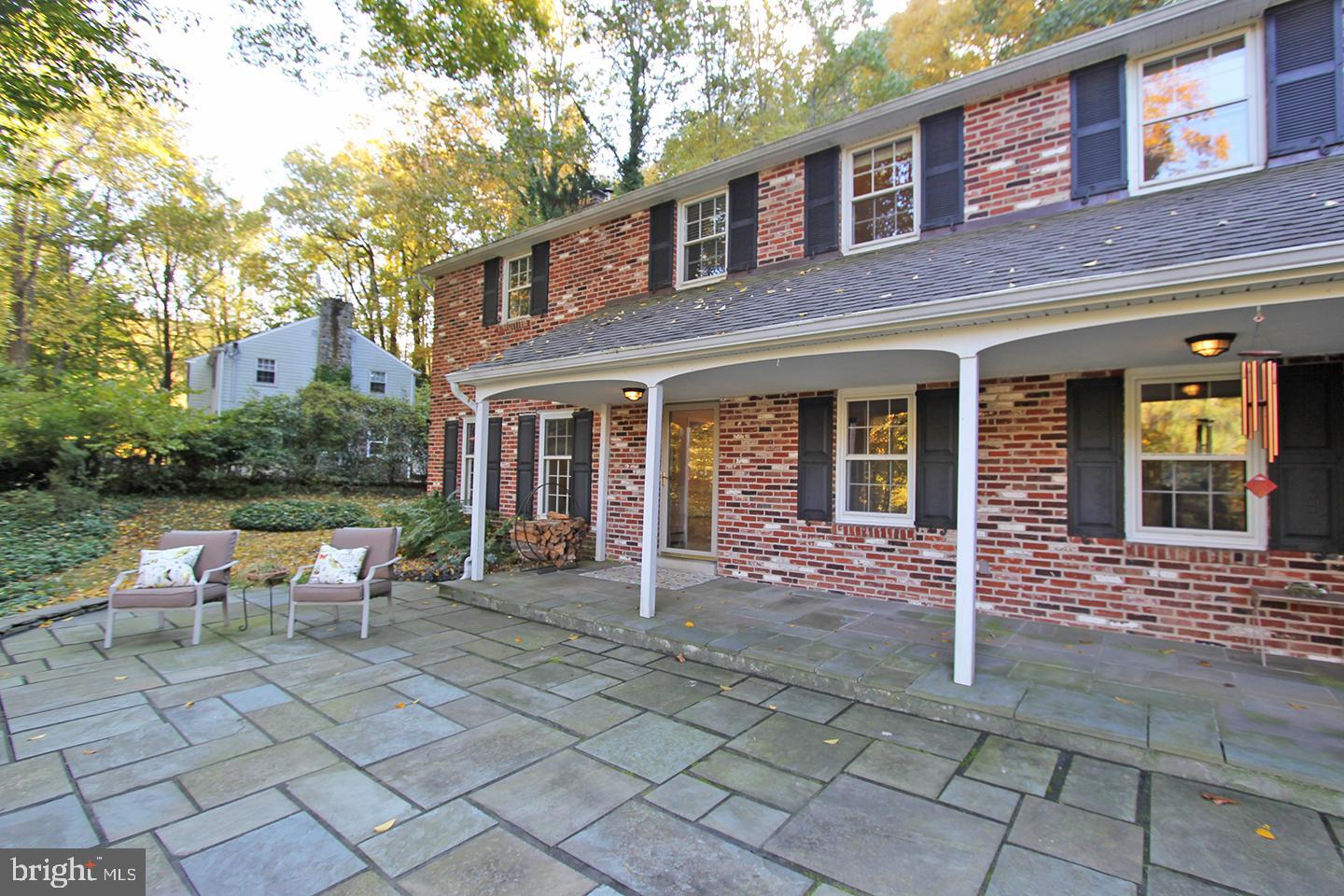 594 Contention Lane Berwyn, PA 19312 - Photo 5 of 15 a view of brick building with a bench and floor to ceiling windows