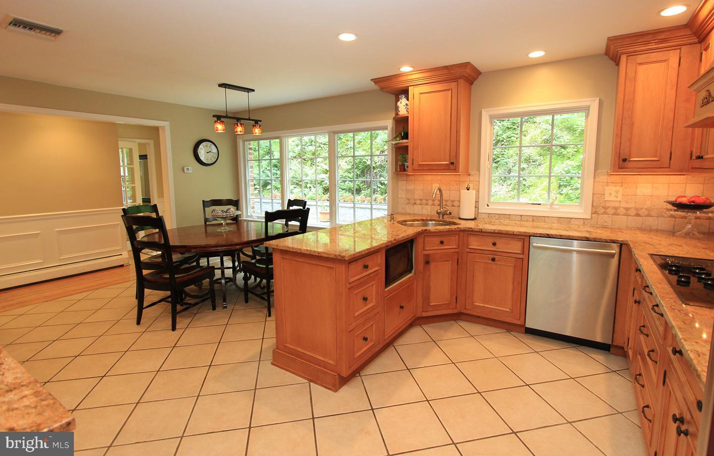 594 Contention Lane Berwyn, PA 19312 - Photo 9 of 15 a kitchen with a sink a stove a table and chairs