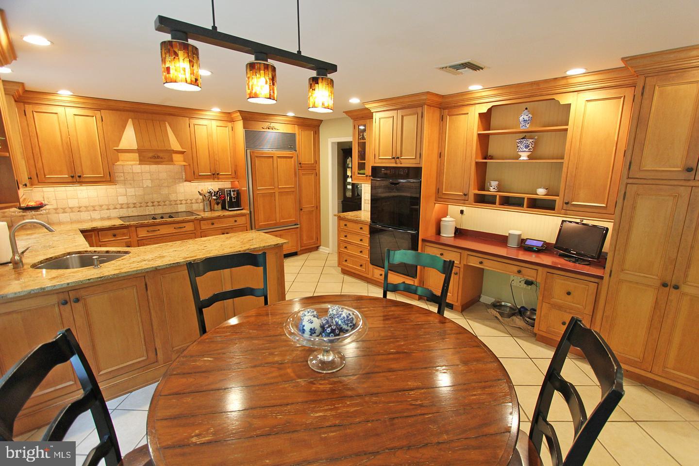 594 Contention Lane Berwyn, PA 19312 - Photo 10 of 15 a kitchen with stainless steel appliances wooden floor and dining table