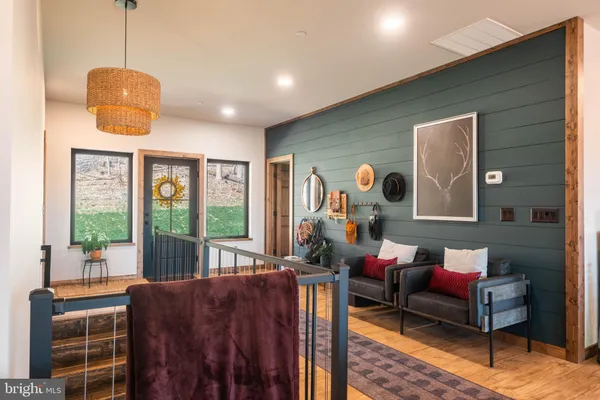 a living room with furniture a rug and a chandelier