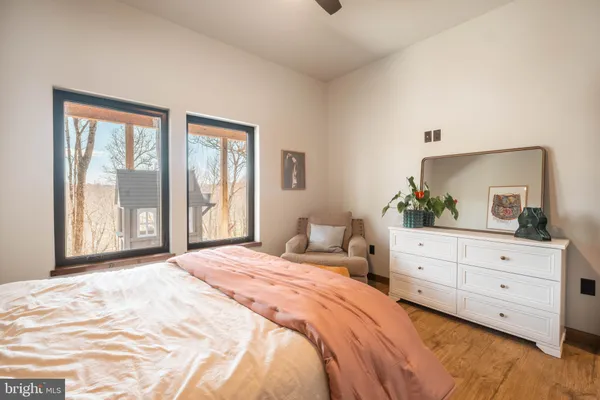 a bedroom with a large bed and a window