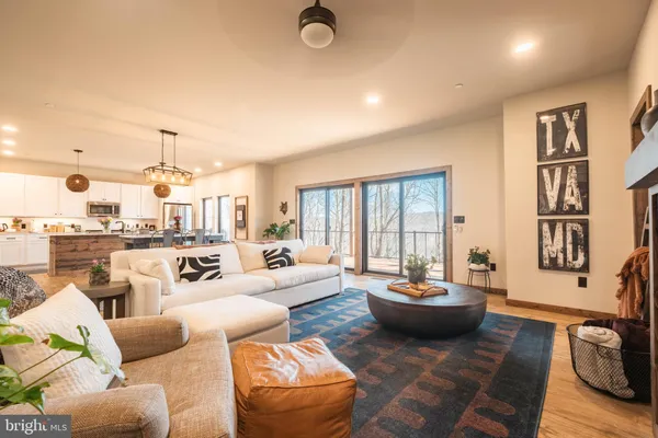 a living room with furniture a rug and a large window