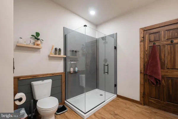 a bathroom with a granite countertop sink toilet and a mirror