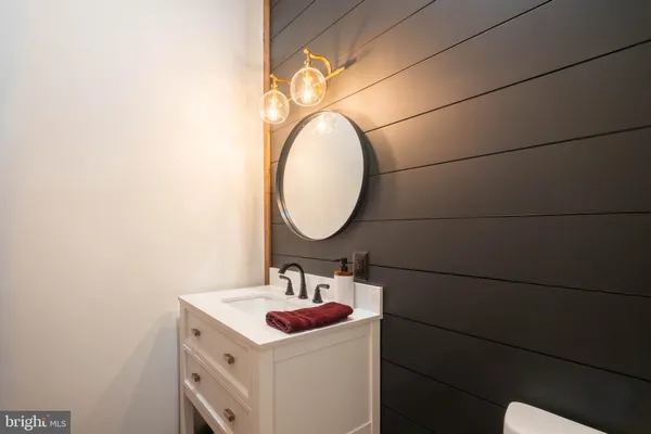 a bathroom with mirror and shower