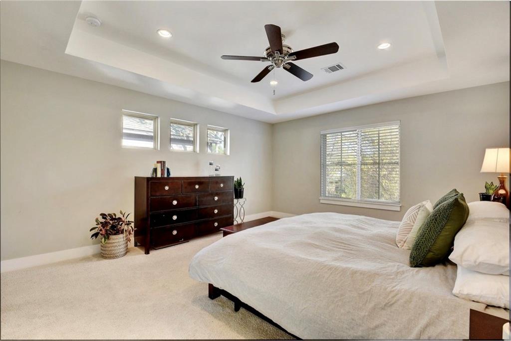 701 East 49th Street, Unit B Austin, TX 78751 - Photo 14 of 27 Bedroom featuring light colored carpet, multiple windows, a ceiling fan, and recessed lighting