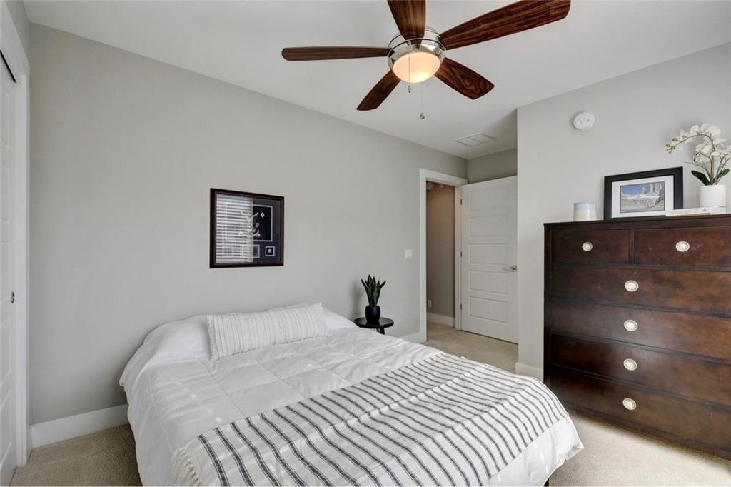 701 East 49th Street, Unit B Austin, TX 78751 - Photo 20 of 27 Bedroom with light colored carpet, a ceiling fan, and a closet
