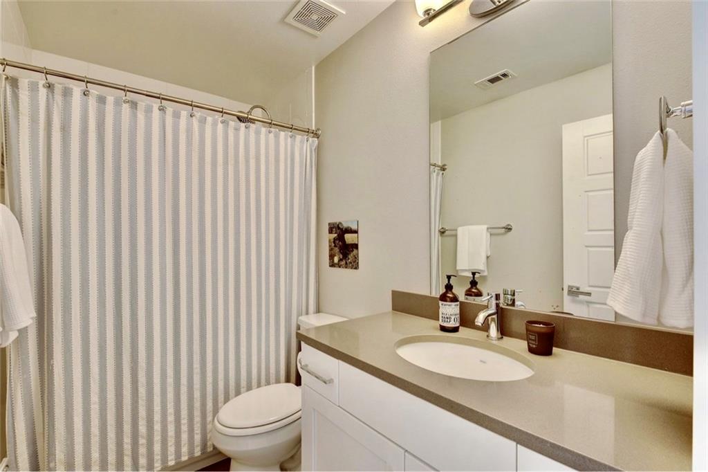 701 East 49th Street, Unit B Austin, TX 78751 - Photo 21 of 27 Bathroom with vanity and a shower with shower curtain