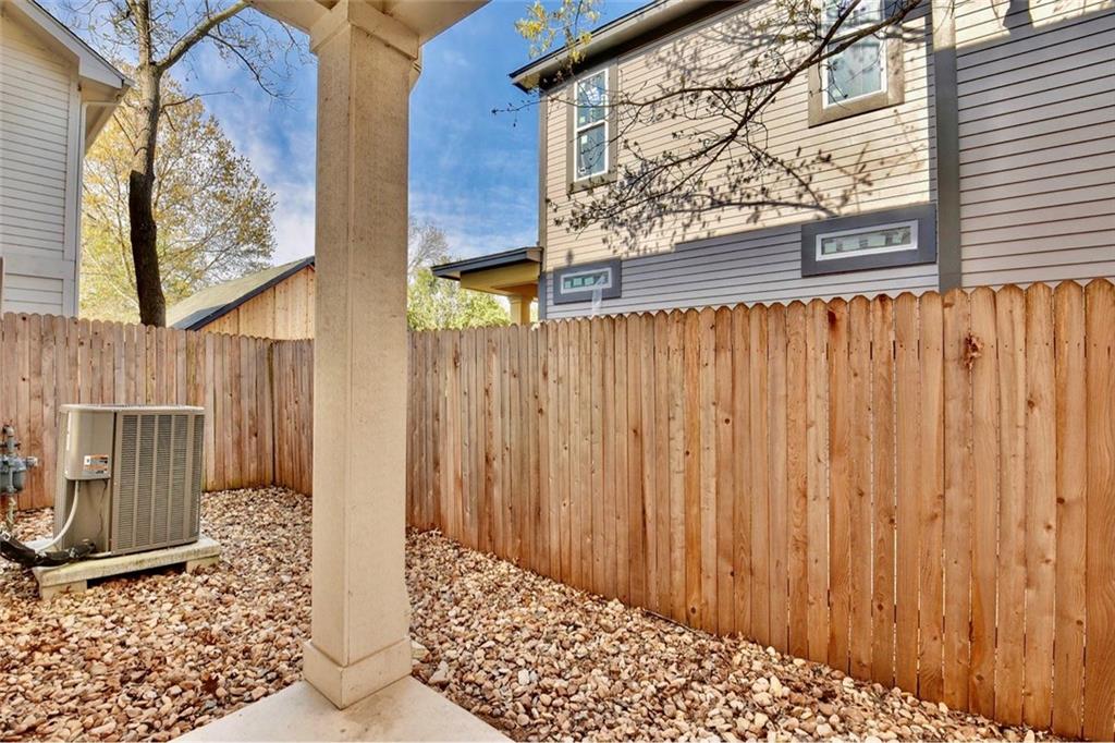 701 East 49th Street, Unit B Austin, TX 78751 - Photo 25 of 27 View of home's exterior with a fenced backyard and a cooling unit