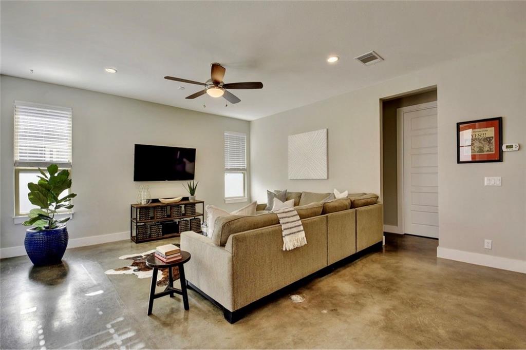701 East 49th Street, Unit B Austin, TX 78751 - Photo 8 of 27 Living room featuring concrete flooring, a ceiling fan, and recessed lighting