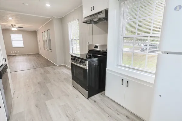 a kitchen with white cabinets and a sink