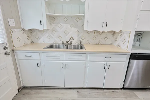a kitchen with granite countertop a stove and a refrigerator