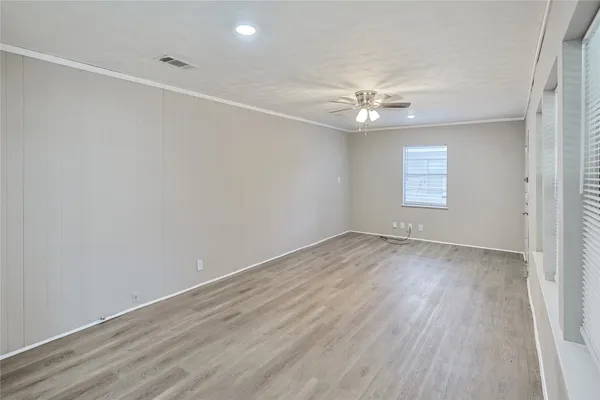 a view of white cabinets with wooden floor