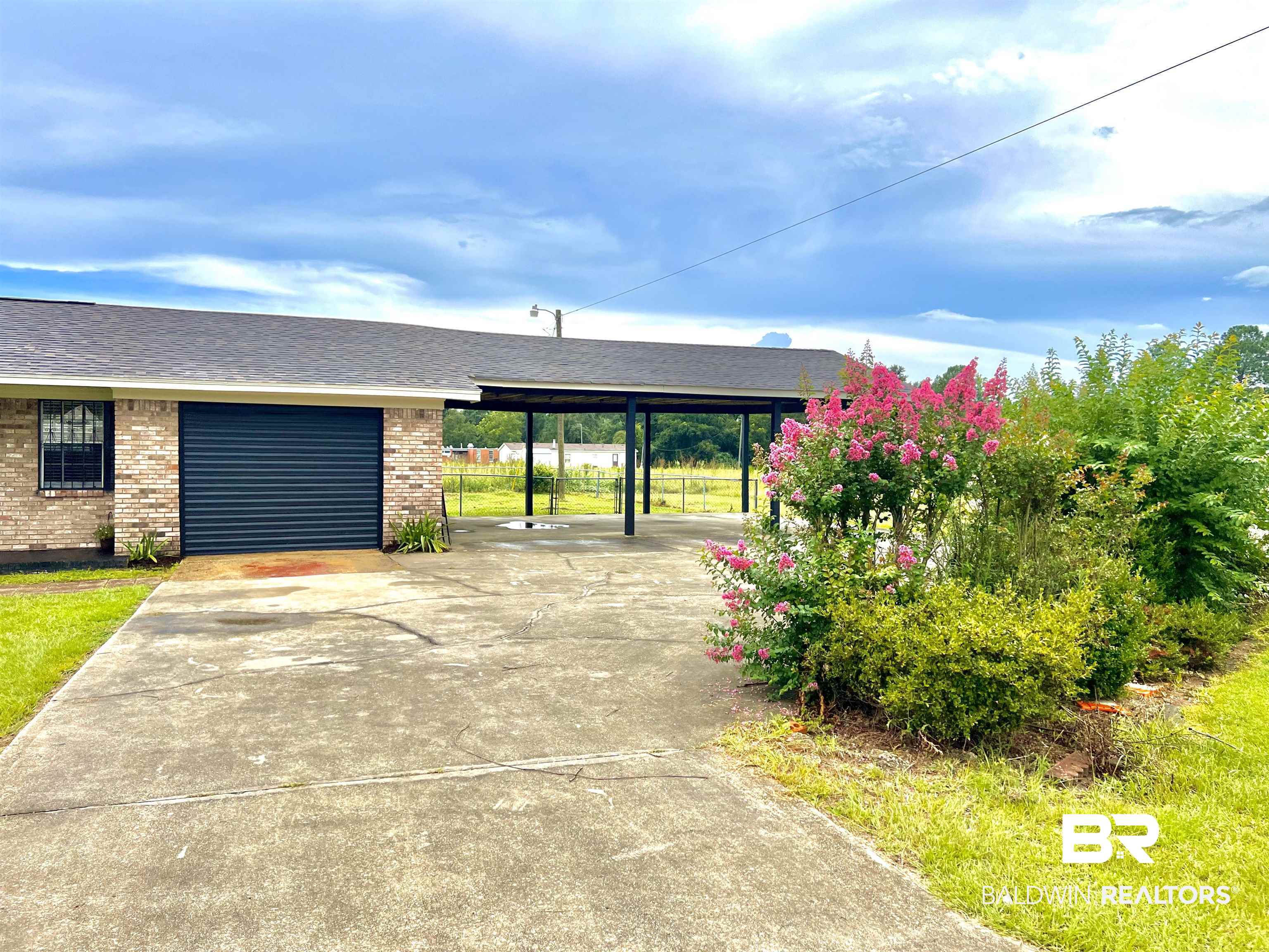 508 Freemanville Drive Atmore, AL 36502 - Photo 25 of 27 Ranch-style home featuring a carport and a garage