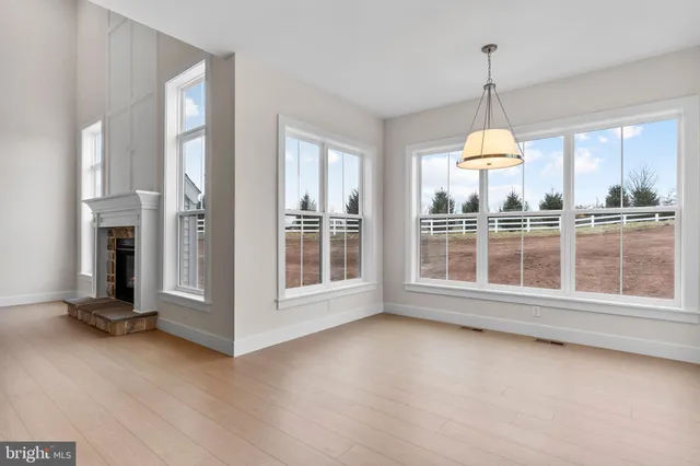 a view of livingroom with furniture large windows and wooden floor