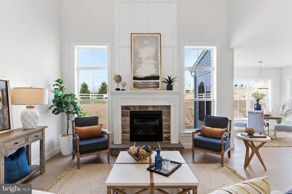 a living room with furniture fireplace and window
