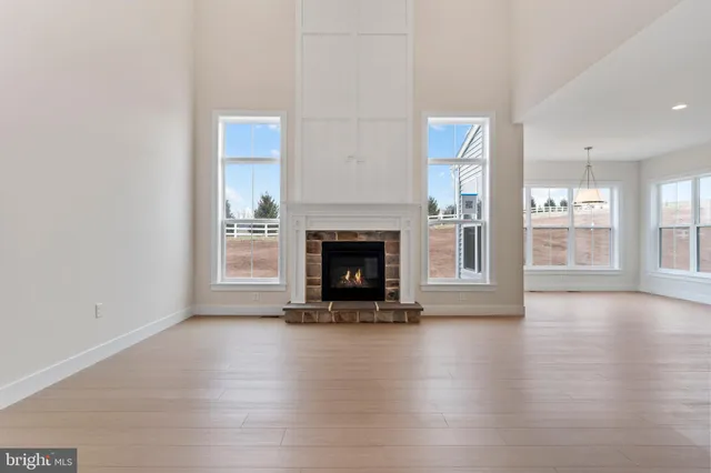 a view of a room with wooden floor fire place and a fireplace