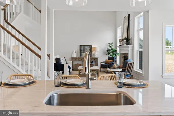 a dining room with furniture a chandelier and wooden floor